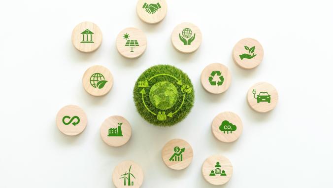 A green ball with an LCA icon surrounded by wooden sustainability icons