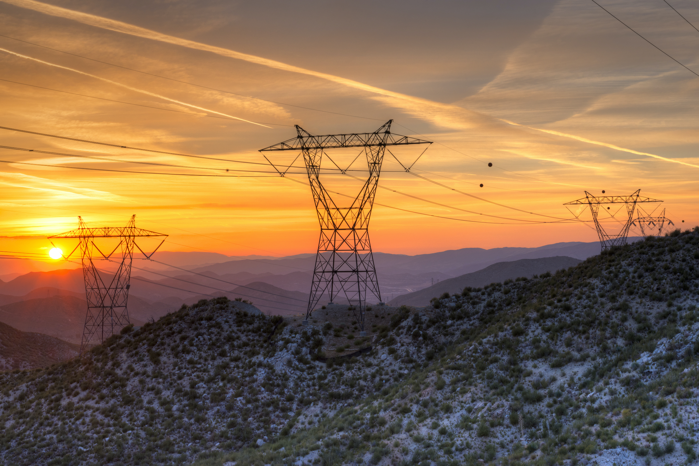 Electric power lines in a California landscape at sunset