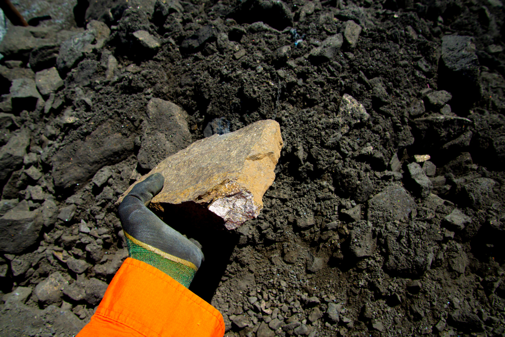 Person holding a sulfide nickel ore rock