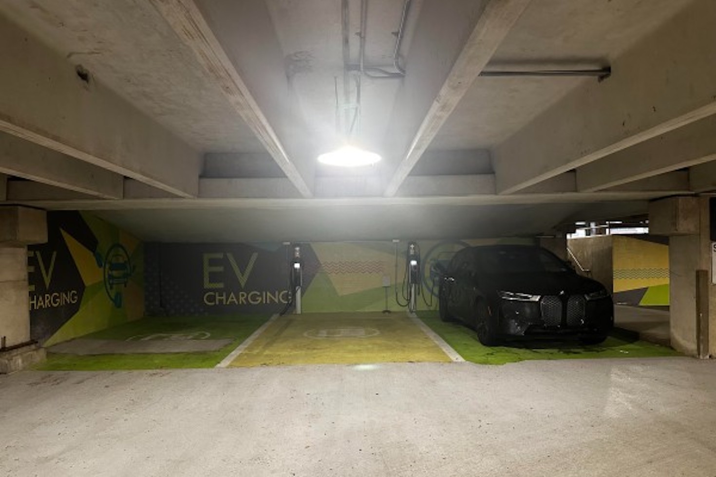 An electric vehicle charging station in a multi-unit parking garage,