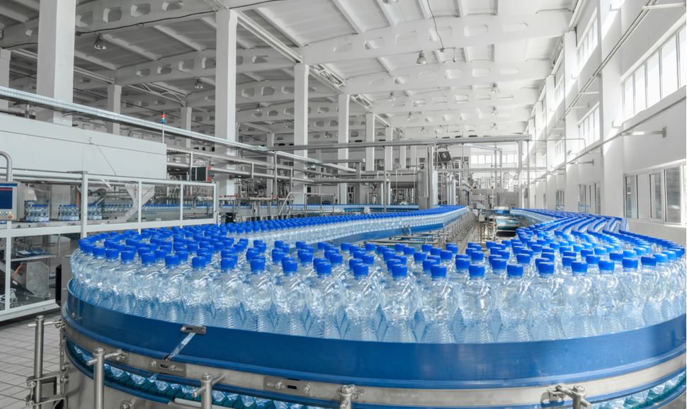 Production of plastic bottles on a conveyor belt in factory