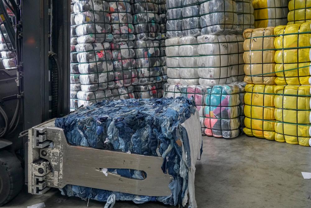 Bundles of used textiles in warehouse