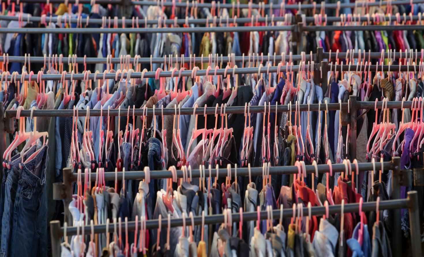 Garments on racks at a thrift store.