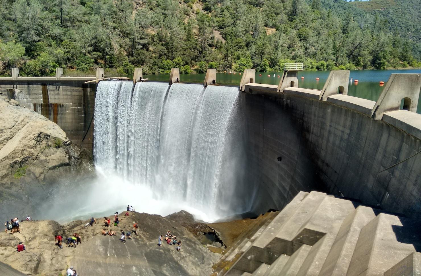 An image of a dam with water spilling over it