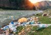 Plastic garbage on a mountain river bank