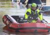 Inflatable raft brings rescue worker through the flooded downtown streets in the aftermath of Tropical Storm Ida.