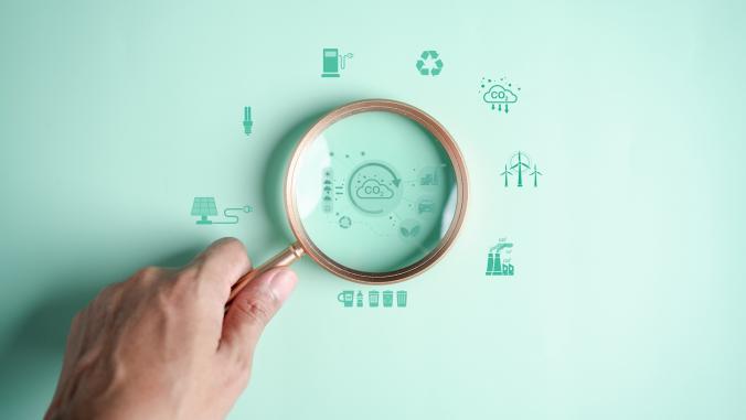 Magnifying glass focusing on sustainability icons